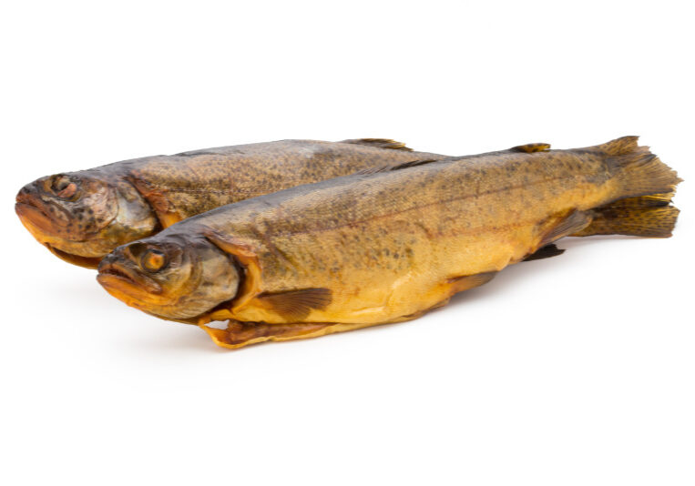 Smoked trout in front of a white background.